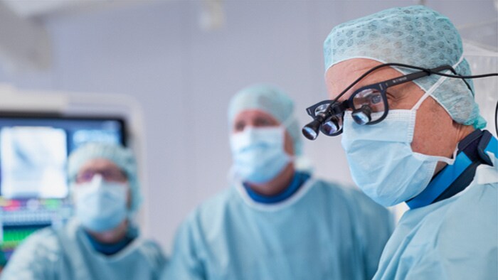 Surgeon looking at monitor during surgery